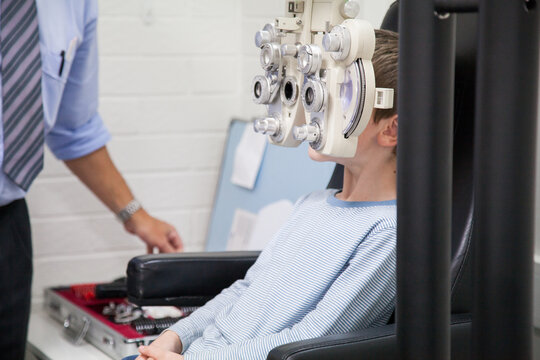 Young boy at an optometrist appointment getting his vision tested