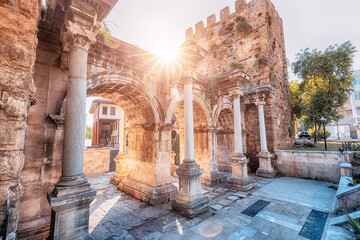 Famous gate or Hadrian arch in Antalya without visitors with sunflare. Travel landmarks and...