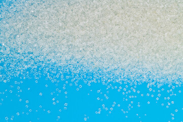Fototapeta premium White sugar crystals on blue background
