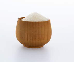 Granulated sugar in a bowl on white background