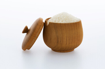 Granulated sugar in a bowl on white background