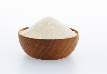 Granulated sugar in a bowl on white background