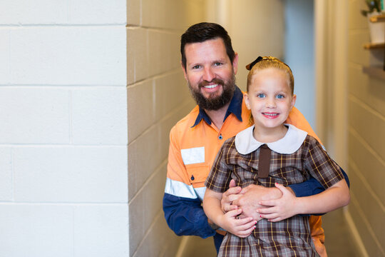 Portrait of a tradie dad with his daughter ready to go back to school and work