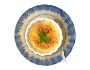Creme brulee in a ceramic bowl isolated on white background