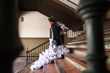 Beautiful teenage woman dancing flamenco with white dress and black polka dots doing flamenco...