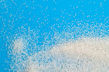 White sugar crystals on blue background