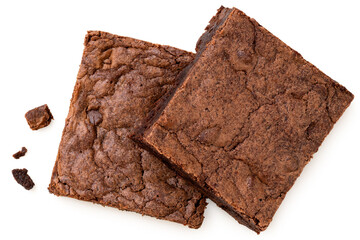Two chocolate brownies with chocolate chips next to crumbs isolated on white from above. - obrazy, fototapety, plakaty