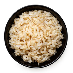 Brown cooked rice in a black ceramic bowl isolated on white from above.