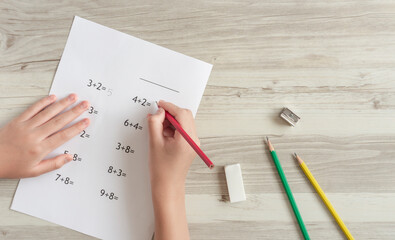 A child solving problems. Arithmetic, addition, calculation, homework, elementary school,...