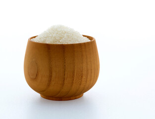 Granulated sugar in a bowl on white background