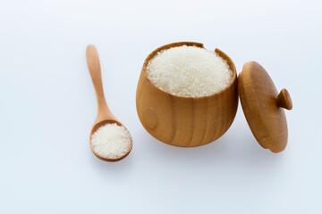 Granulated sugar in a bowl on white background