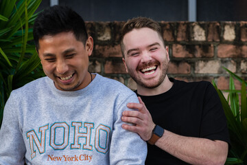 gay men sitting outside, laughing