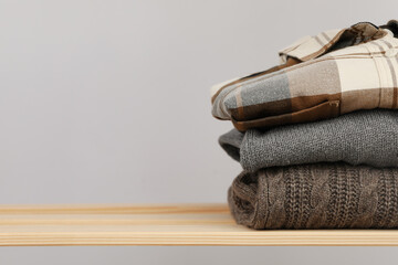 Wooden shelving with clothes, space for text