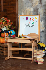 Interior of elementary school. Chalkboard, backpack, pencils and stationery on classroom. Teachers Day. Back to school. Empty classroom with blackboard and wooden table. Kindergarten.	
