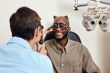 Optical exam, optician or eye doctor at work testing vision or sight of patient at optometrist....