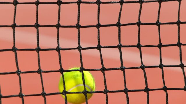 Super Slow Motion Shot of Tennis Ball Hitting the Net on Court at 1000fps.