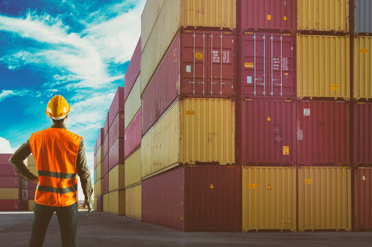 Man at work among containers in a commercial port