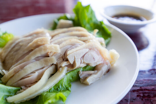 Slice of steamed chicken on plate