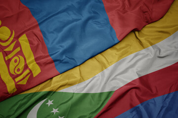 waving colorful flag of comoros and national flag of mongolia.