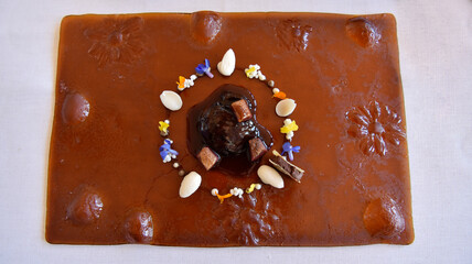 Oxtail stew, almonds with wildflowers and foie. Amazing dish. Spanish Typical cosine.
