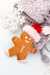 Gingerbread man, cookies and Christmas decor on pastel background.