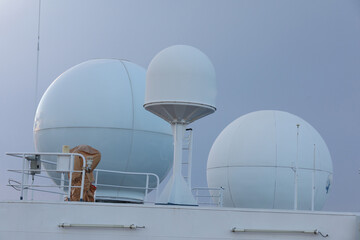 Ship structures, masts, antennas, funnel, ship wheelhouse against the blue sky and clouds. Vessel...
