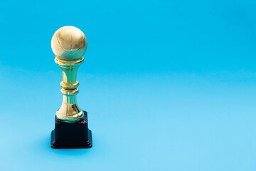 Golden basketball trophy on blue background