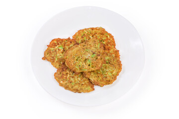 Fried thick savory zucchini pancakes on the white dish