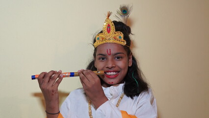 Indian kid dressed up as little krishna Shrikrishna or kanha kanhaiya on fancy dress Gokulashtami...