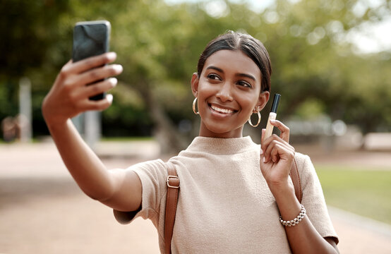 Phone selfie of fashion, style and beauty vlogger smiling for social media content in a park. Wellness, glamour and lifestyle influencer marketing makeup while looking elegant and trendy outdoors