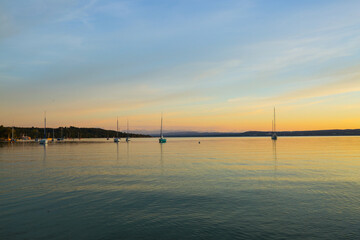 Fototapeta na wymiar Sailing boats on the Ammersee in the sunset