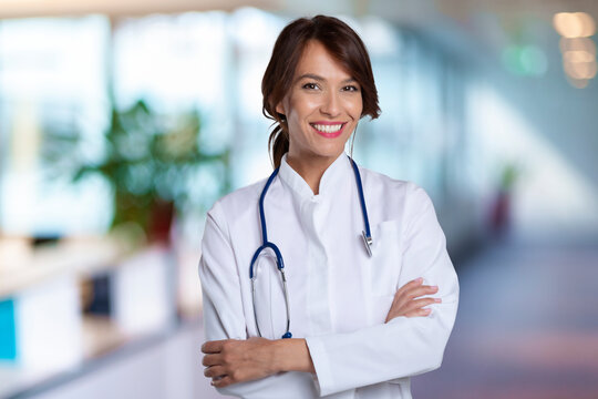 Portrait of attractive female doctor while standing at clinic's foyer