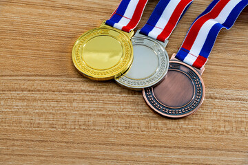 Three medals on wooden table