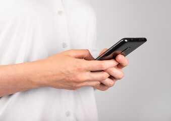 Woman hands texting message at phone. Female using messenger at Android for chatting or surfing Internet. Modern lifestyle with telephone concept. Profile view. High quality photo