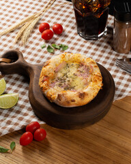 Sfiha on a wooden table with ingredients