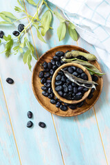 Raw organic vegetables. The concept of vegan or diet food. Fresh ripe black soy beans on a wooden table. View from above. Copy space.