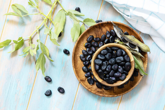 Raw Organic Vegetables. The Concept Of Vegan Or Diet Food. Fresh Ripe Black Soy Beans On A Wooden Table. View From Above.