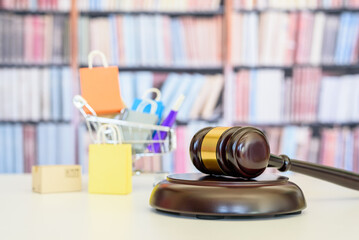 Consumer protection law, rights and guarantees, financial justice concept : Judge gavel, bags in a...