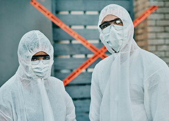 Covid, coronavirus and outbreak healthcare workers inspecting contamination on site with red tape, protective masks and suits. Portrait of medical team working together to fight a contagious disease