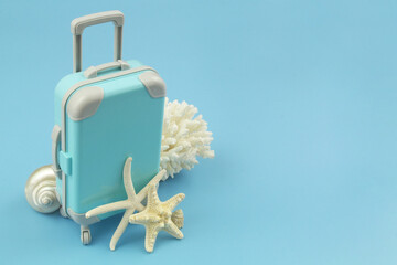 Travel and vacation concept. Travel suitcase with starfishes, seashells and coral with space for text.	