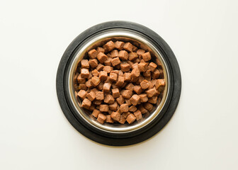 The metal bowl for animals with wet food on white background