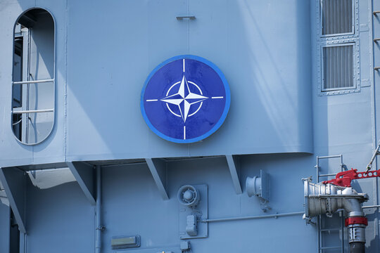 The logo sign of NATO placed on a military vessel ship. North Atlantic Treaty Organization concept image. Romania, 2022.