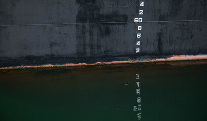 The water depth measurement system guidance numbers placed on the side of a big vessel ship in the sea