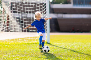 Kids play football. Child at soccer field. © famveldman