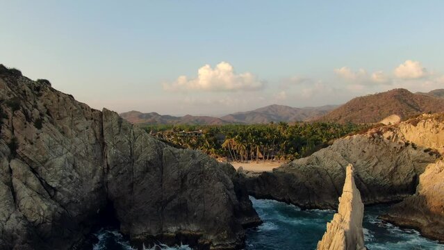 Dedo De Dios Cliffs And Rocks At Maruata Beach In Michoacan, Mexico At Sunset - drone shot
