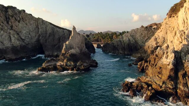 Rugged Landscape At Playa Maruata With Its Famous Dedo de Dios In Michoacan, Mexico - drone shot