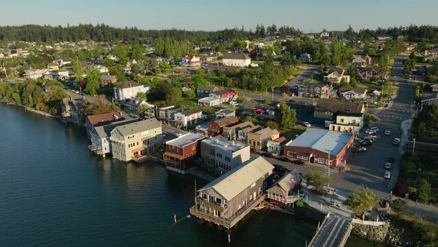 Drone shot pulling away from Coupeville's main street amenities to show the entirety of the city and the wharf.