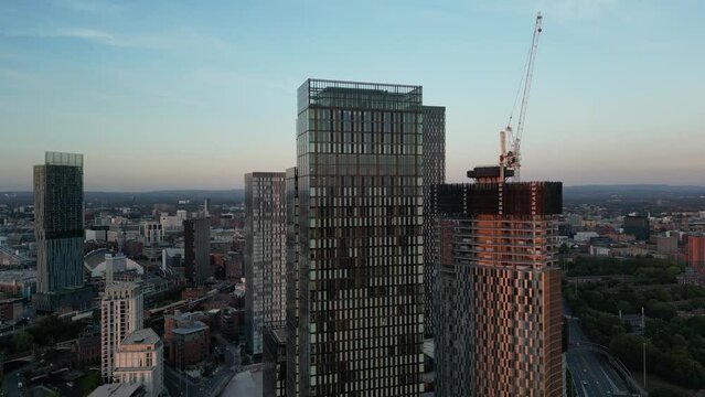 Aerial drone flight around Deansgate Towers showing skycrapers and new construction of skyscrapers in Manchester United Kingdom
