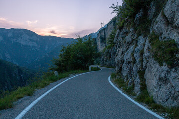 curvy road in mountain during sunset.