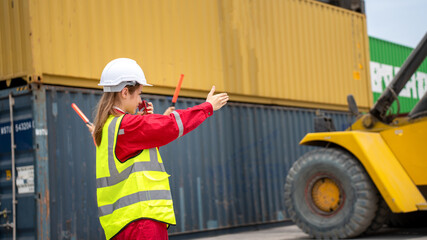 Woman Foreman and Operator Hand Signal for Driver forklift for loading Cargo container at warehouse internatinal cargo port © Yellow Boat